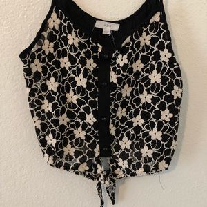 Strappy flower top with tie at the bottom.